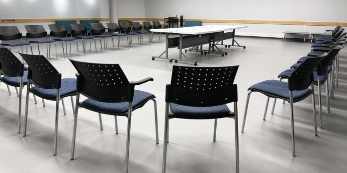 Friends of the Library Community Room with chairs set up in a half moon with tables in the middle