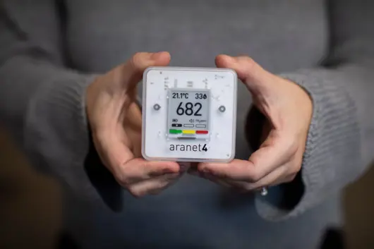 Hands holding a Carbon Dioxide Monitor